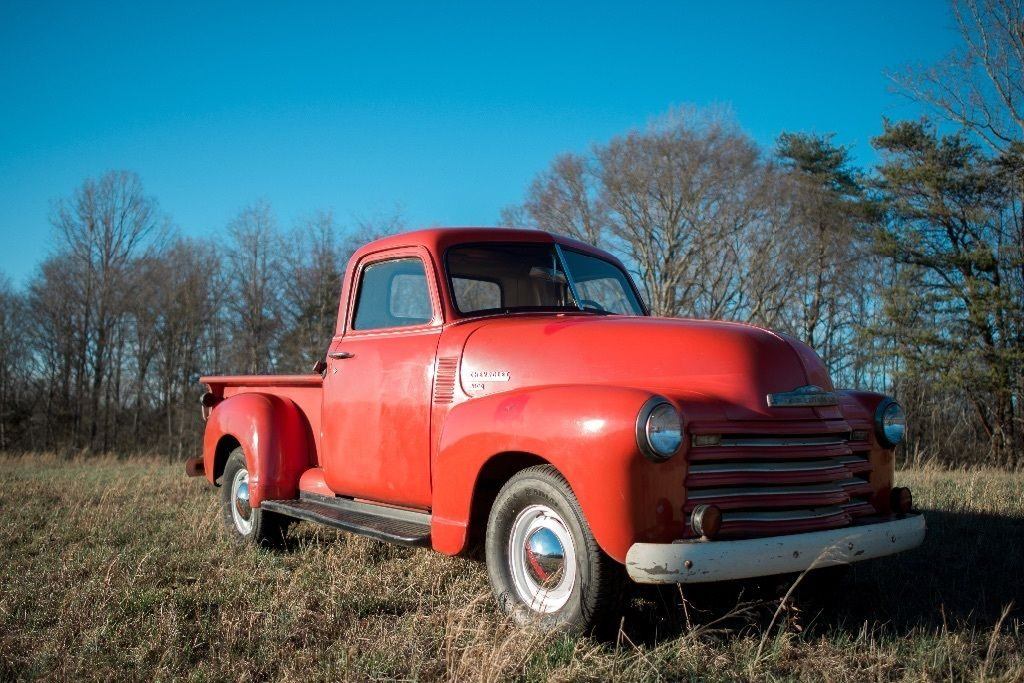 Red 1950 Chevy 3100 pickup truck